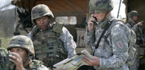 U.S. Army Field Artillery Soldiers adjusting M119