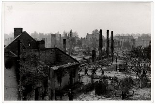 Poles walk among the ruins of besieged Warsaw.