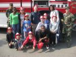 Photo 2: SSgt Andrea Simmonds, Capt Jay Bragga, and SrA Shameka Scarborough get ready for the fire truck tour
