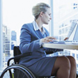 Woman in Wheelchair working in an office
