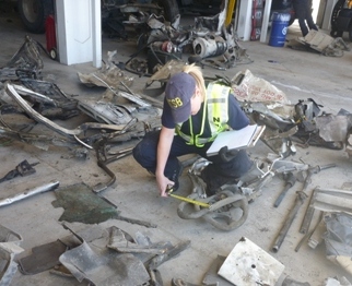 NTSB investigator Jennifer Morrison examining wreckage in Nevada