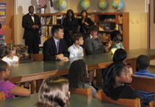 Students and officials watch President's broadcast speech. Click for larger image.