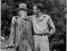 Wendell Berry with arm around statue