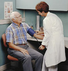 Physician checking a patient's blood pressure. - Click to enlarge in new window.