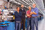 Part of the SLAC team that worked on self-seeding is shown alongside the hardware in the LCLS Undulator Hall. From left: John Amann, Henrik Loos, Jerry Hastings and Jim Welch. Photo by Matt Beardsley, SLAC National Accelerator Laboratory 