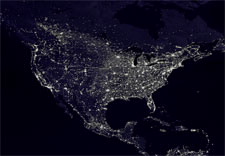 NASA satellite photo of North America at night, showing points of light "describing" the electrical grid. Click for more information and access to larger image.