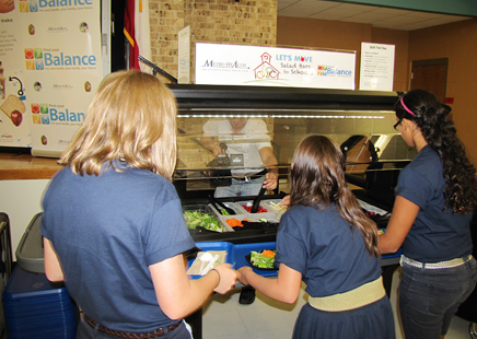 Students at Jackson Middle School—North East Independent School District select fresh veggies from the new salad bar at their cafeteria. Photo courtesy of Communities Putting Prevention to Work.