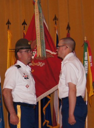 Staff Sgt. George E. Williams participates in the pinning of the Engineer castle branch insignia on Pvt. David L. West II. West graduated One Station Unit Training, Aug. 31, 2012, after losing more than 100 pounds to meet Army enlistment requirements.