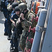 <p>U.S. Sailors assigned to the guided missile destroyer USS Mustin (DDG 89) and Platoon 503, Explosive Ordnance Disposal Mobile Unit 5 conduct a helicopter visit, board, search and seizure drill in support of Valiant Shield 2012 aboard the Mustin in the Pacific Ocean Sept. 13, 2012. Mustin was part of the George Washington Carrier Strike Group. Valiant Shield is a biennial U.S. Air Force, Navy and Marine Corps exercise held in Guam, focusing on real-world proficiency in sustaining joint forces at sea, in the air, on land and in cyberspace. (DoD photo by Mass Communication Specialist 2nd Class Devon Dow, U.S. Navy/Released)</p>