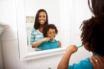 Boy looking in the mirroe , brushung his teeth