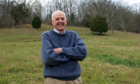 Wendell Berry, standing in a field, color photo