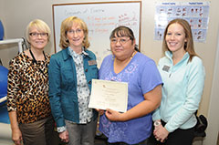 DIHFS staff members posing with a successful Fork n' Road Weight Management Program client.