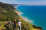 People standing on a bluff overlooking the King Range and Lost Coast.