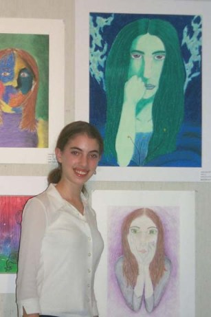 Guest artist posing with her art