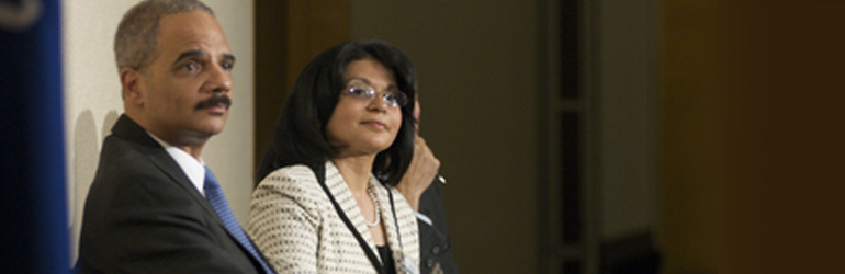 Assistant Attorney General Ignacia Moreno is seating next to Attorney General Eric Holder