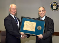 Dr. Winokur congratulating Victor Stello