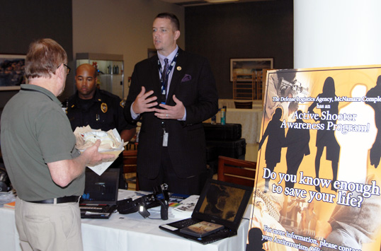 Photo: Employees speaking at display table