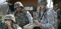 U.S. Army Field Artillery Soldiers adjusting M119