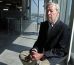 ECO-SENIOR: Robert MacArthur, founder of GreenCampusPoints, sits in his MassChallenge work space at One Marina Park Drive in Boston.