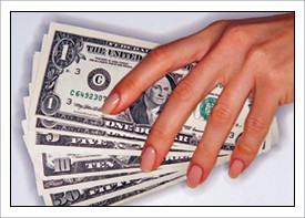 Woman’s hand on U.S. currency