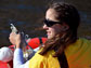 Photo of student Marisa LaRouche sampling water from a Greenland lake.