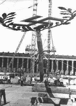 A  Maypole topped with a swastika is raised for a May Day parade in the Lustgarten in Berlin. The May holiday became an important celebration in the Nazi calendar. Germany, April 26, 1939.