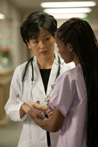 a female doctor talking to a female nurse