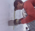 Photo of scientist Noah Molotch sampling snow density in a snow pit.