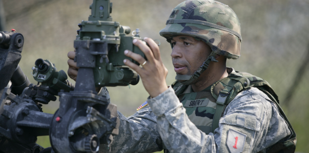 U.S. Army Field Artillery Sergeant Sibert making adjustments