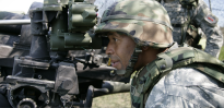 U.S. Army Field Artillery Sergeant Sibert verifying adjustments