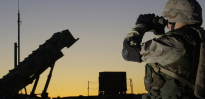 Soldier views a Patriot missile through binoculars 