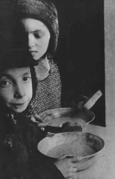 In the Warsaw ghetto, Jewish children with bowls of soup. Warsaw, Poland, ca. 1940.