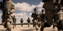 Soldiers running across fight line