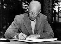 Photograph of President Eisenhower signing the 1954 Social Security Amendments initiating the disability "freeze."