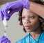 Nurse with syringe and vial of medicine.