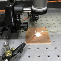 Collimated output of the solar simulator illuminates a small solar cell.