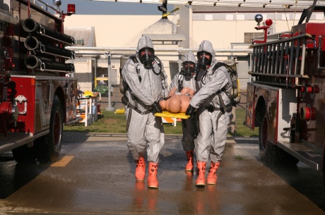 Mayor Richard Hildreth (pictured front-left), of Pacific, Wash., assists his team of emergency responders transport a simulated survivor through the initial stage of decontamination during an exercise. Hildreth attended training at the Center for Domestic Preparedness (CDP), in Anniston, Ala., and has completed several CDP courses over the past two years. CDP training instructs responders to determine their response, select required equipment, personal protective levels, and decontamination procedures. 