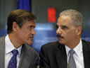 Juan Fernando Lopez Aguilar, Chairman of the European Parliament Committee on Civil Liberties, Justice and Home Affairs speaks with Attorney General Eric Holder during his appearance before the committee.