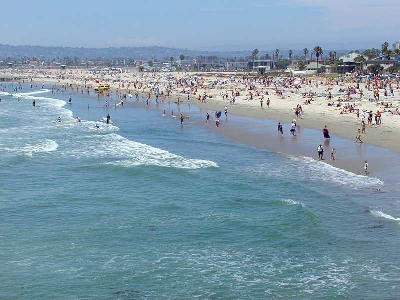 swimmers-and-surfers-in-ocean-water-on-waves-in-san-diego