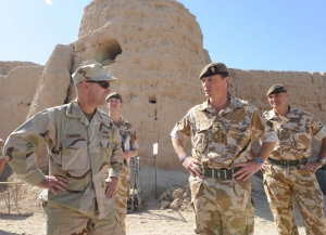 Receiving a briefing at Forward Operating Base Shawquat in Nad e-Ali by British troop commander Lieutenant Colonel Roley.