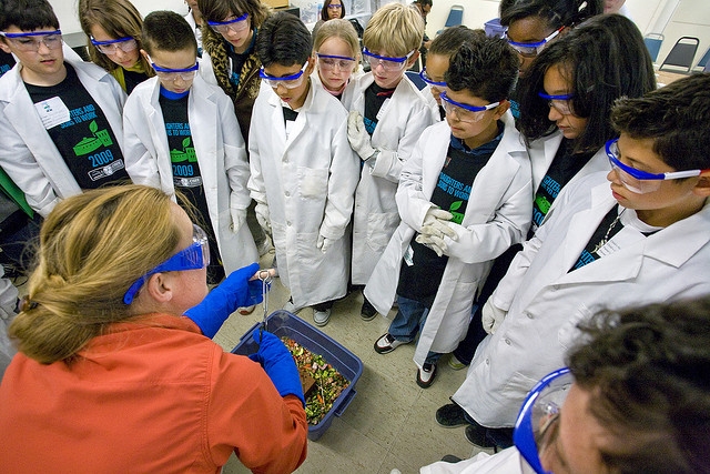 An LBNL scientist explains the properties of liquid nitrogen to students on Bring Your Sons and Daughters to Work Day. | Courtesy of Lawrence Berkeley National Lab | Credit: Roy Kaltschmidt.
