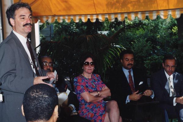 Circa 1995:  A DS special agent (left) provides a security briefing to (left to right) U.S. Representative Charles Rangel, Deputy Chief of Mission Priscilla Clapp, U.S. Secretary of Commerce Ronald Brown, and U.S. Ambassador Princeton Lyman in Pretoria, South Africa. (Source: Private Collection)