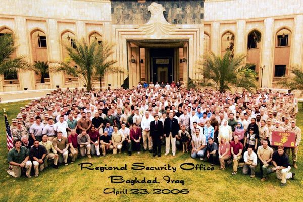 April 23, 2006:  Regional Security Office personnel in Baghdad appear in front of the interim United States Embassy, former palace of deposed Iraqi leader Saddam Hussein.  Included are logistics personnel, contractors, Marine Security Guards, military police, K-9 dog handlers, and several contract personal security detail professionals.  (Source:  U.S. Embassy Baghdad)