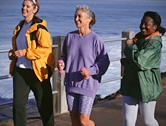 Three women walking on the pier