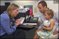 Photo: A doctor consulting a father and child.