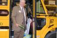 Ed McNeel, superintendent of Corbin's school district, poses aboard the district's new hybrid-diesel bus. | Photo Courtesy of Susie Hart.