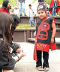 Lillian Marvin (Tlingit), age 7, shows her octopus bag to sightseers.
