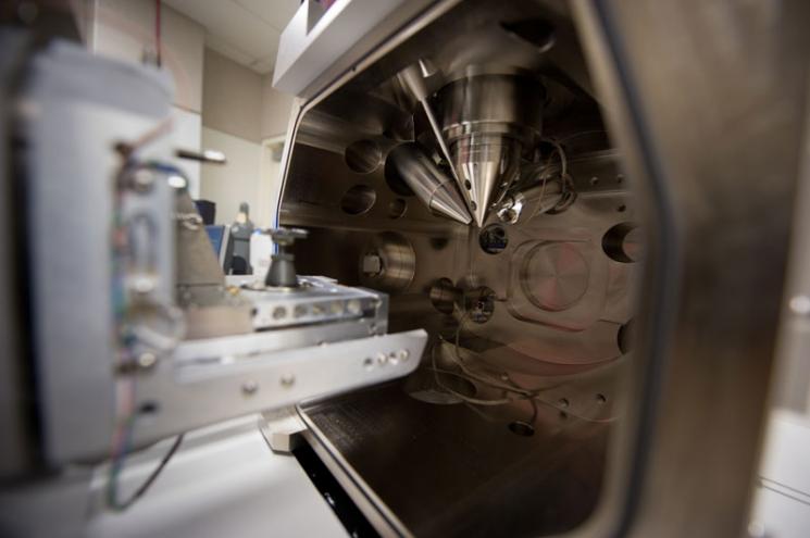 The inside of the specimen/vacuum chamber of NREL's FEI Nova 200 dual beam electron microscope used to analyze the topography of materials such as Innovalight's Silicon Ink. The instrument is used to produce site-specific sections for high spatial microstructural analysis. 