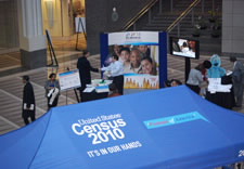 Image of people attending event with tent inside of Ronald Reagan Building. Click for larger image.