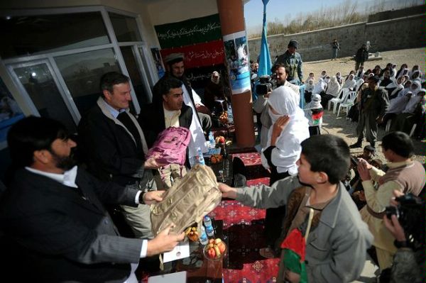 U.S. Ambassador Karl W. Eikenberry tours Paktya province in Afghanistan. On one of the stops, Eikenberry hands out school supplies at a newly constructed school for boys and girls. 